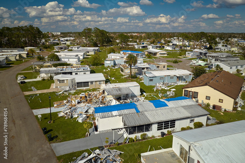 Severely damaged by hurricane Ian houses in Florida mobile home residential area. Consequences of natural disaster