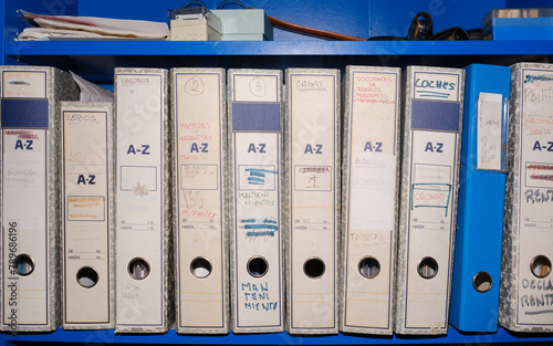 Receipt archive folders in blue shelf