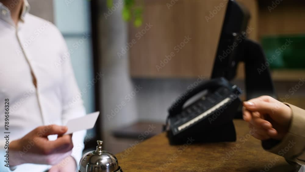 Guest gives card keys to the receptionist in hotel lobby. Check out from hotel Guest gives card keys to the receptionist in hotel lobby. Check out from hotel