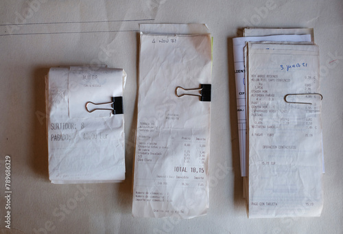 Piles of Receipts categorized with paperclips and pliers  photo