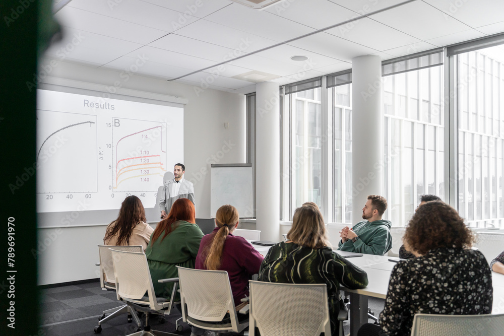 Man Performing PhD Thesis Defence To Audience Man Performing PhD Thesis Defence To Audience