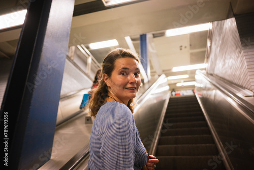 Young Woman on Escalator in Subway Station photo
