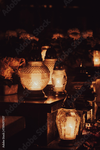 Cemetary decorated with candles for All Saints Day at night