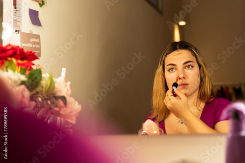 woman applying contouring makeup  photo