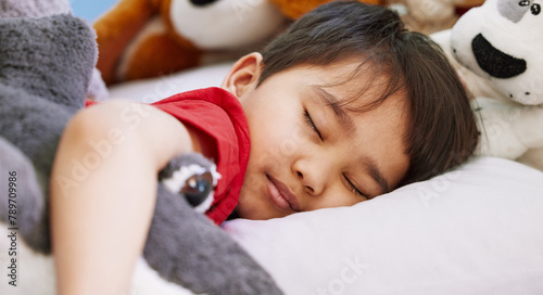 Asian boy, baby and sleeping in bedroom, home and nursery for peace, calm and dreaming at nap time. Tired, toys or young male kid resting for break, growth and healthy childhood development in house
