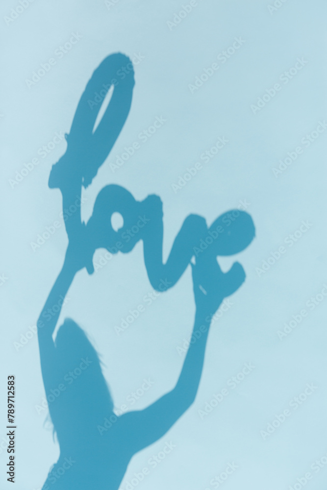 Shadow of a woman holding a balloon with the word Shadow of a woman holding a balloon with the word