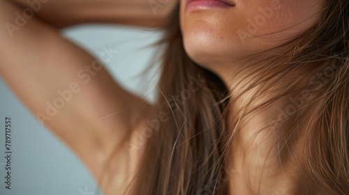 A closeup of a womans armpit showcasing the natural growth of hair that has been long stigmatized and shamed. .