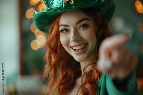 Attractive redhead woman in Saint Patrick's Day leprechaun costume laughing and pointing, perfect for party invitation or celebration