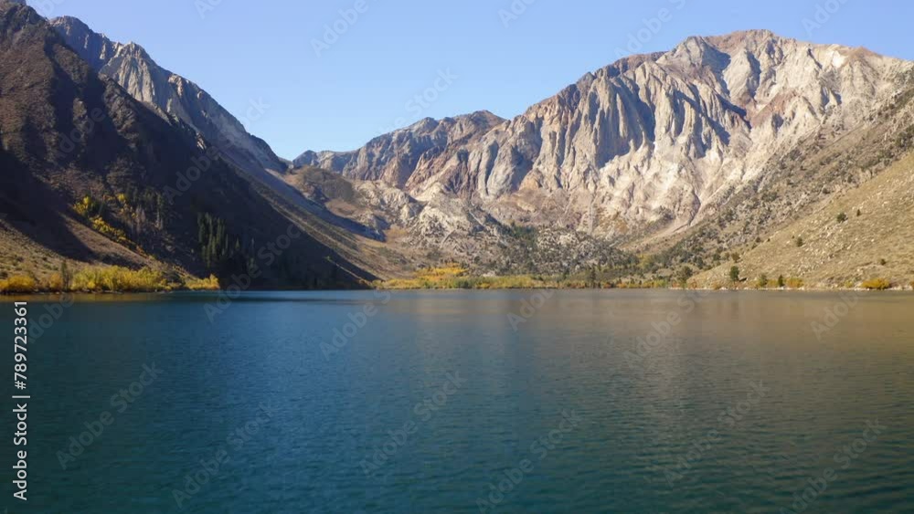 Aerial: Beautiful Shot Of Mountains Against Clear Sky, Drone Flying Forward Over Rippled Lake On Sunny Day - Mammoth Lakes, California Aerial: Beautiful Shot Of Mountains Against Clear Sky, Drone Flying Forward Over Rippled Lake On Sunny Day - Mammoth Lakes, California