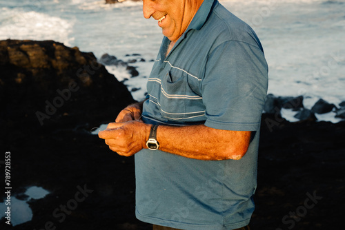 Close-up of a fisherman preparing his bait photo