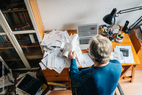 Man working in cluttered desk