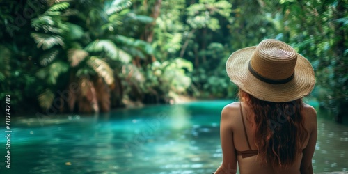 Beautiful woman gazing at tranquil tropical river, surrounded by lush greenery, evoking feelings of peaceful summer escapes and nature retreats. Copy space © BrightWhite
