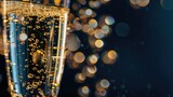 Close-up of sparkling beverage in fluted glass with bubbles and bokeh background
