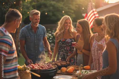Family and friends enjoy a backyard summer barbecue grill cookout dinner party