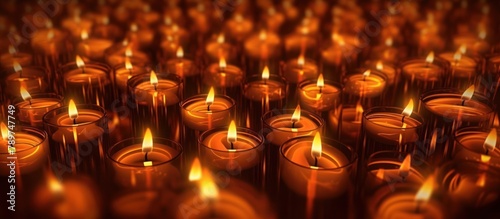 Abstract candle background. Many candle flames glowing on dark background