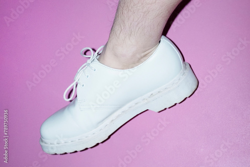 Woman with shin hair wearing shoes. Image normalizing female body hair photo