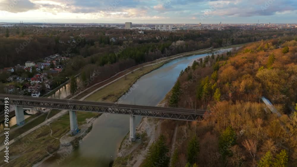 Grosshesseloher Brucke on Isar River in Munich, Germany aerial view. Two-story railroad and pedestrian bridge in Munchen over Isar River. Eisenbahnbrucke. Bike path runs under Railroad tracks. Grosshesseloher Brucke on Isar River in Munich, Germany aerial view. Two-story railroad and pedestrian bridge in Munchen over Isar River. Eisenbahnbrucke. Bike path runs under Railroad tracks.