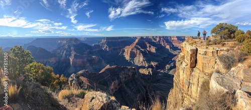 Visitors Enthralled by Canyons Breathtaking Panorama from Cliffside Viewpoint photo