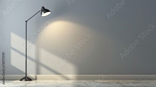 Light gray wall with a solitary industrial metal lamp photo
