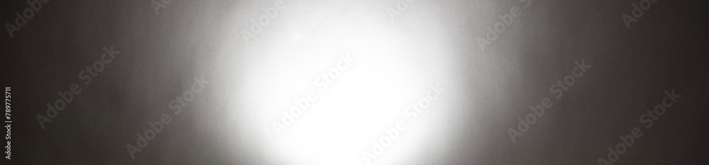 A horizontal gray background with a white circle in the middle. The photography texture material. Use for web smooth monochrome shadow banner. Gray color for the futuristic trend fashion. A horizontal gray background with a white circle in the middle. The photography texture material. Use for web smooth monochrome shadow banner. Gray color for the futuristic trend fashion.
