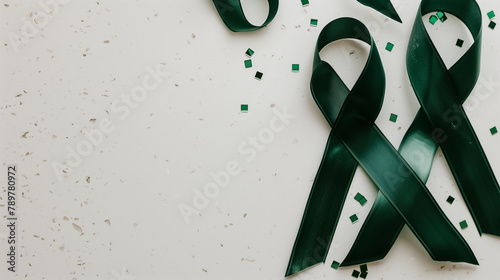 Emerald Green Cancer support ribbon for liver gallbladder bile duct kidney organ donation lyme disease mental health cerebral palsy blank plain background copy space healthcare fundraiser awareness photo