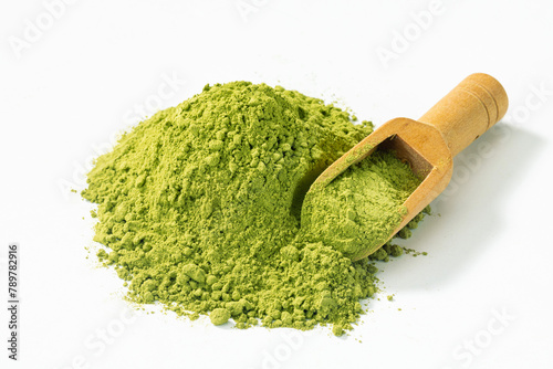 matcha green tea powder with tea scoop on white background.