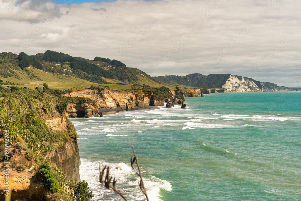 Obraz premium Pillars of rock formations rising from the sea on the Taranaki coastline