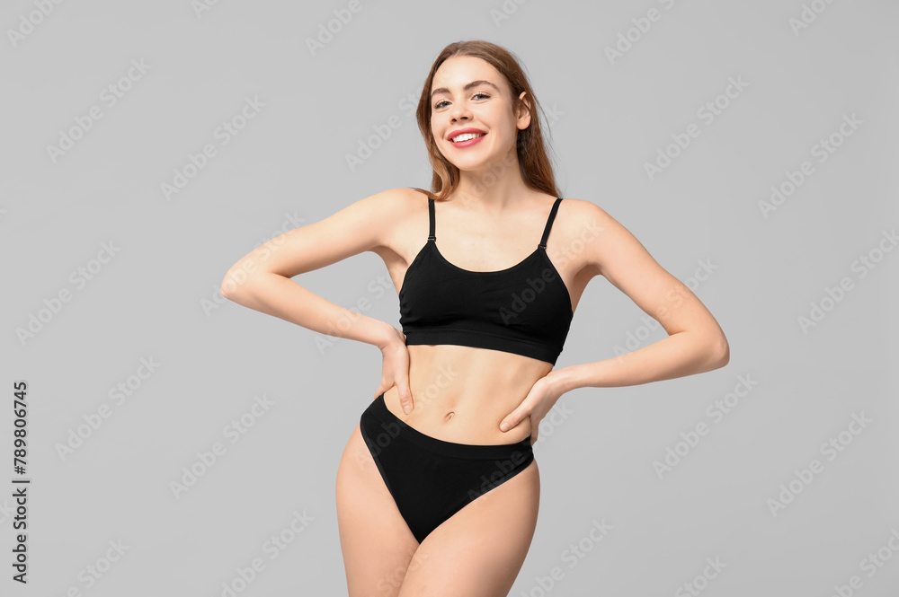 Beautiful young woman in black cotton underwear on light background - obrazy, fototapety, plakaty 