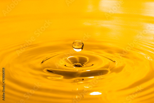 yellow drop oil , Liquid gold oil drop ripple background. © Nattapol_Sritongcom