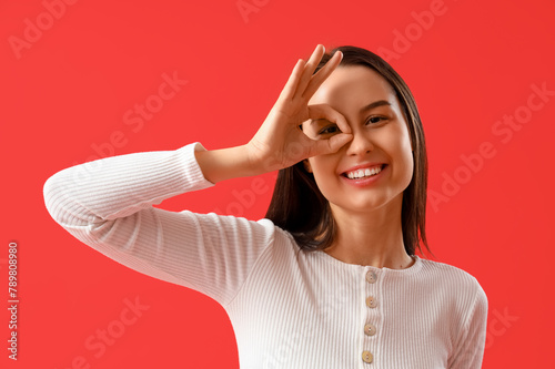 Young woman showing OK on r...