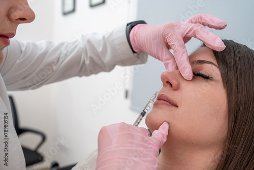 Beautician injecting Botox for nose beauty treatment: cosmetic procedure for skin rejuvenation and nasal enhancement