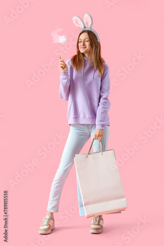 Young woman in bunny ears w...