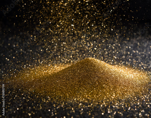 Gold dust powder sparkling glitter black background texture