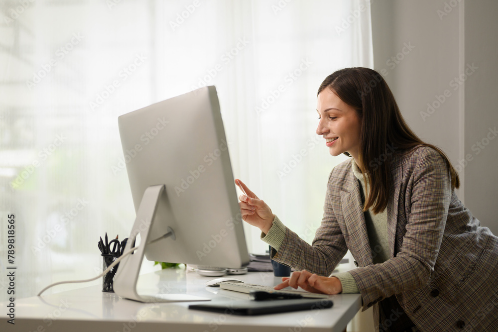 Attractive businesswoman talking by conference online virtual chat on computer at home office Attractive businesswoman talking by conference online virtual chat on computer at home office