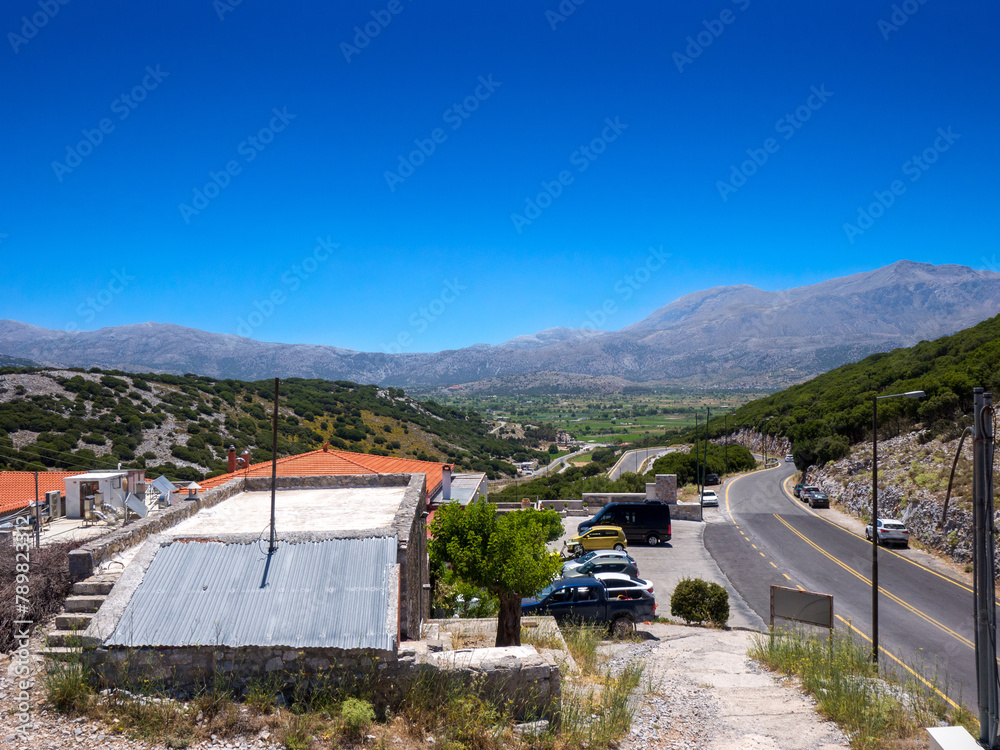 Looking down into the distance from a plateau over buildings (Lasithi Plateau, Crete, Greece)