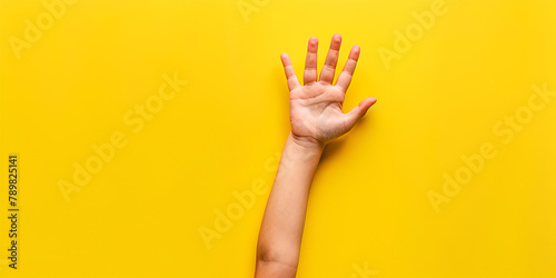 Children's palm on a yellow background with copy space Baby child boy hands on yellow background Closeup