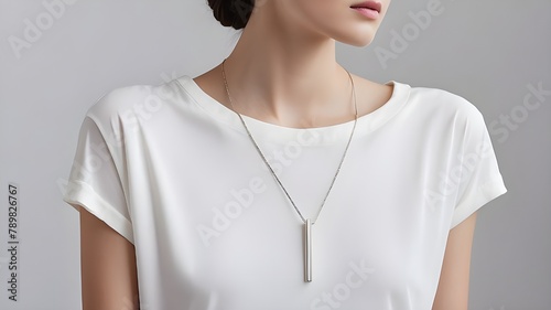 :A minimalist bar-shaped pendant suspended on a slender silver chain, exuding modern sophistication–