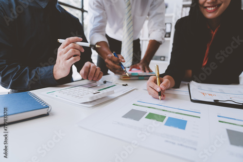 Team work process Team of business people searching for piles of papers and having a meeting Discuss business statistics, profits, financial growth rates in graph papers. financial data chart.