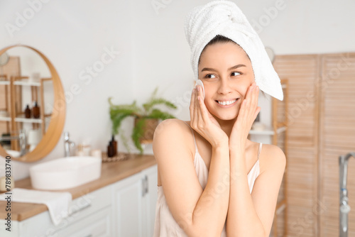 Young woman with cotton pad...