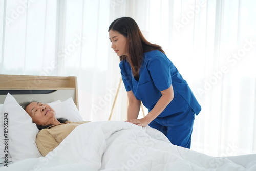 Healthcare Support: Nurse Assistant Help Senior Woman Rest Comfortably at Home