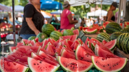 A bustling watermelon stand at a farmers market, vibrant red slices displayed alongside whole melons. A cool summer breeze carries the sweet scent of watermelon. 
