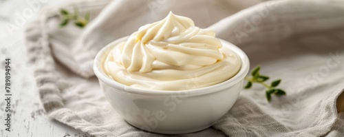 Mayonnaise sauce in white bowl on dining table