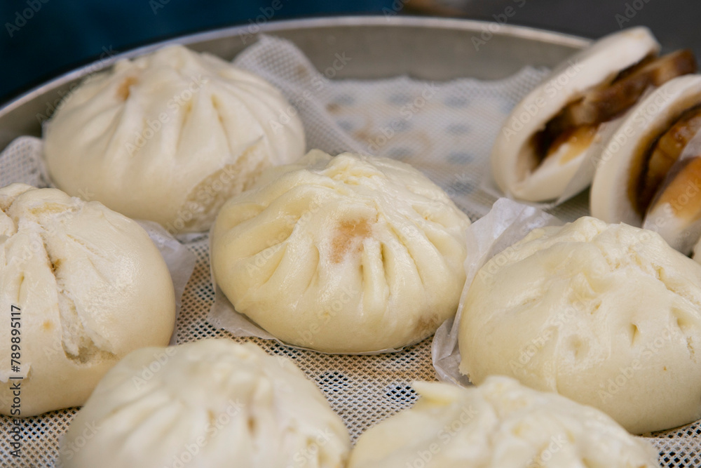 Chinese steamed buns filled with pork, street food in Nankin-machi neighborhood in Kobe, Japan. Chinese steamed buns filled with pork, street food in Nankin-machi neighborhood in Kobe, Japan.
