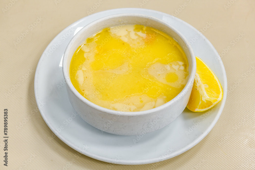Homemade turkish soup Tavuk Suyu corbasi in a white ceramic soup plate.Turkish noodle chicken broth soup on a plate. Turkish meal (sehriyeli tavuk suyu corbasi) Homemade turkish soup Tavuk Suyu corbasi in a white ceramic soup plate.Turkish noodle chicken broth soup on a plate. Turkish meal (sehriyeli tavuk suyu corbasi)