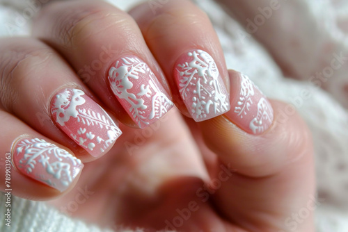 Close-up of Elegant White Lace Patterned Nail Art on Feminine Hands
