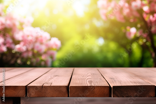 Empty wooden table in front of abstract blurred spring flowers background for product display in a coffee shop, local market or bar