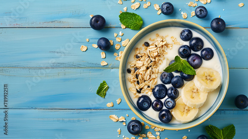 Dark blue bowl of oatmeal porridge with banana and blueberry on vintage table top view in flat lay style. Hot breakfast and homemade food. Free space. Homemade cuisine. Generative Ai