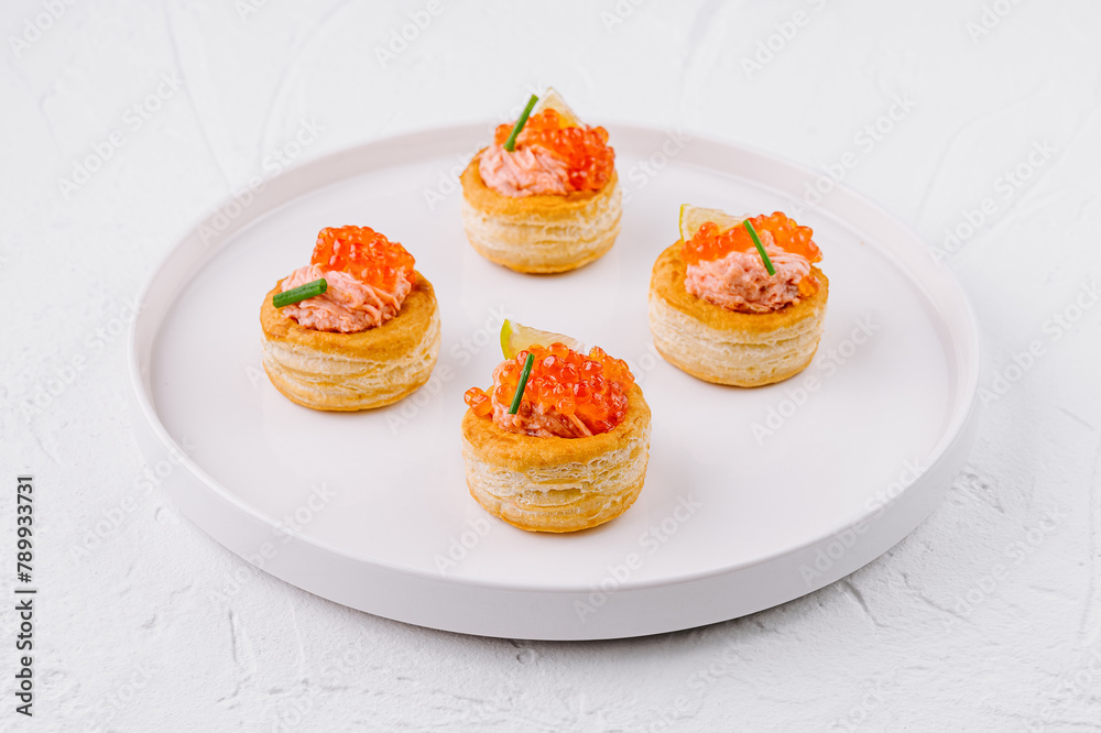Elegant salmon tartare appetizers on white plate