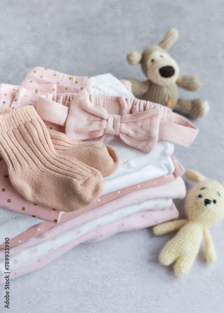 Stack of Baby bodysuits on a grey background. Stack of Baby bodysuits on a grey background.