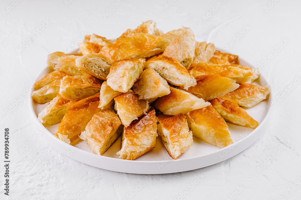 Freshly baked puff pastry bites on plate Freshly baked puff pastry bites on plate